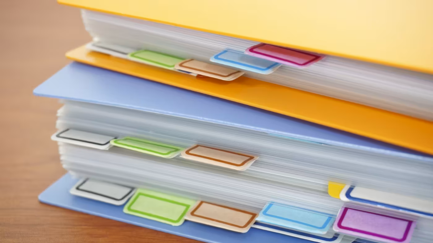 A stack of tabbed document folders seen from the side