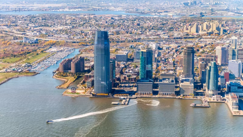 Aerial view of the Jersey City waterfront with its towers and the marina below