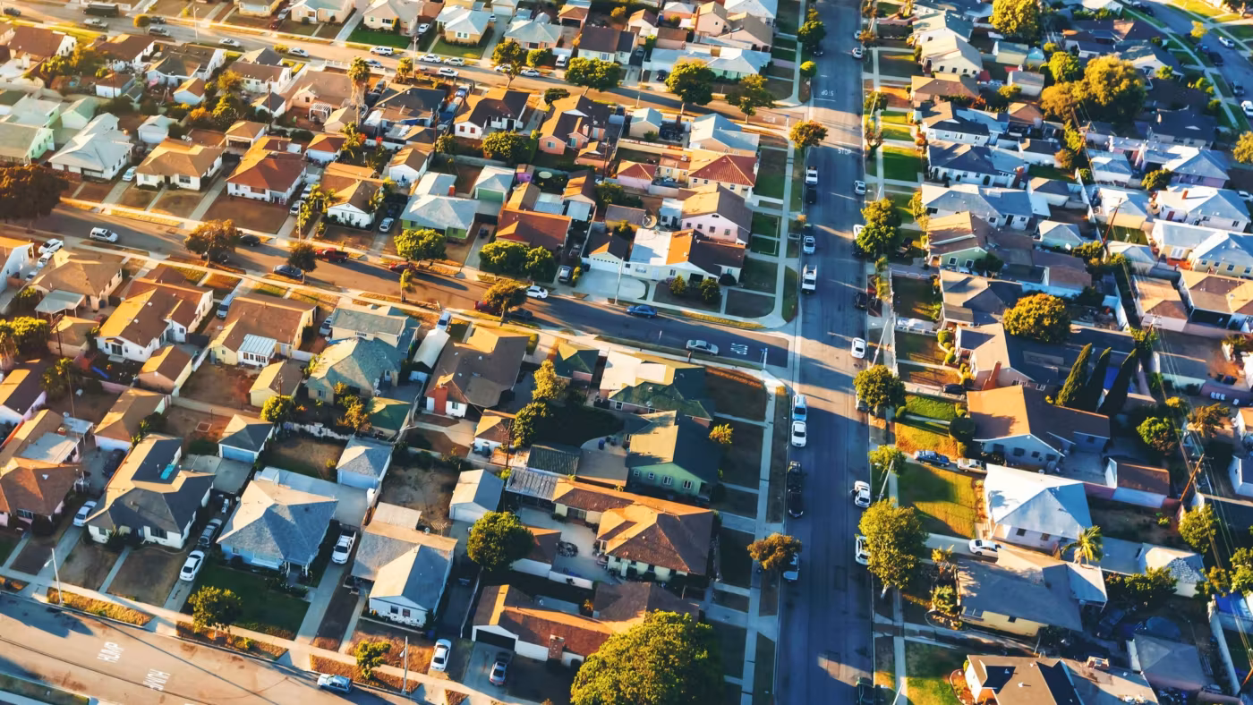 Aerial view of tightly packed Los Angeles houses and streets at golden hour