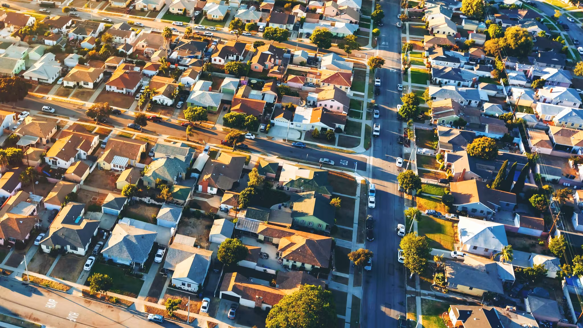 Aerial view of tightly packed Los Angeles houses and streets at golden hour