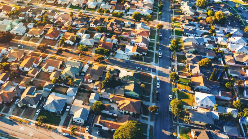 Aerial view of tightly packed Los Angeles houses and streets at golden hour