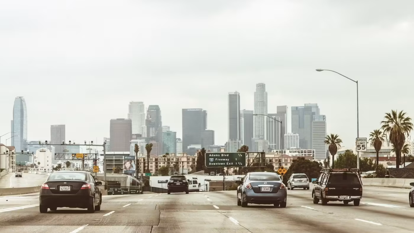 Traffic on a Los Angeles freeway with the downtown towers ahead