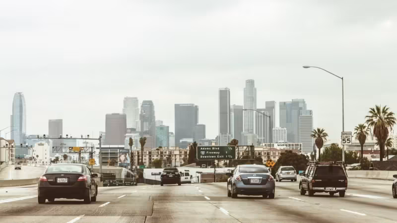 Traffic on a Los Angeles freeway with the downtown towers ahead