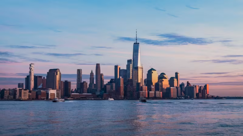The Lower Manhattan skyline seen across the water at dusk
