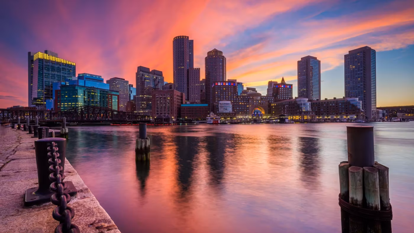 Boston harbour at sunrise with old pilings in the foreground