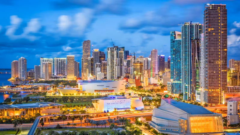 Downtown Miami lit at dusk, seen from above