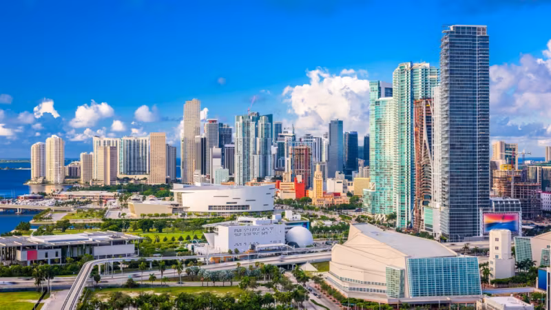 Downtown Miami's towers beside the bay on a bright day