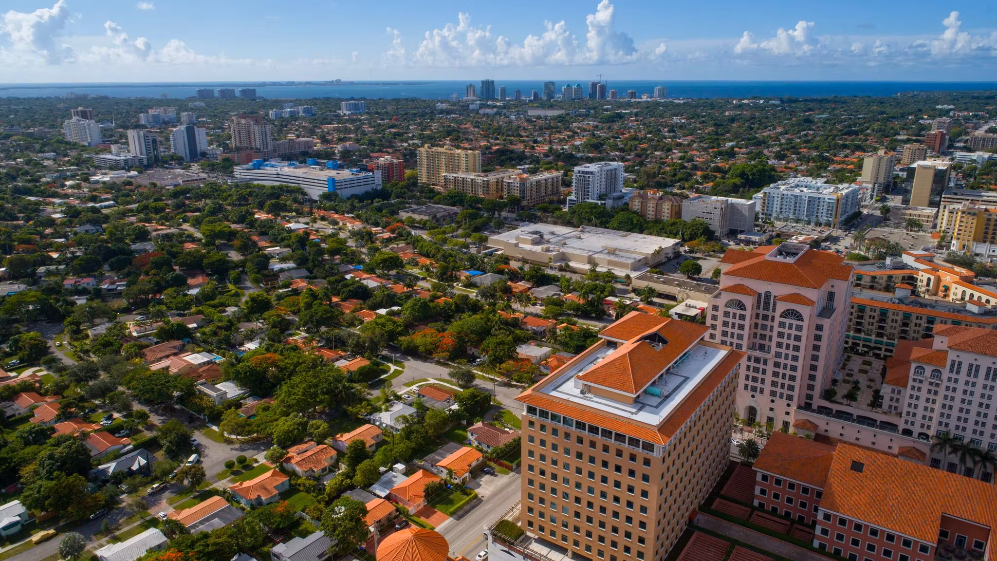 Aerial view of tile-roofed Miami homes among trees