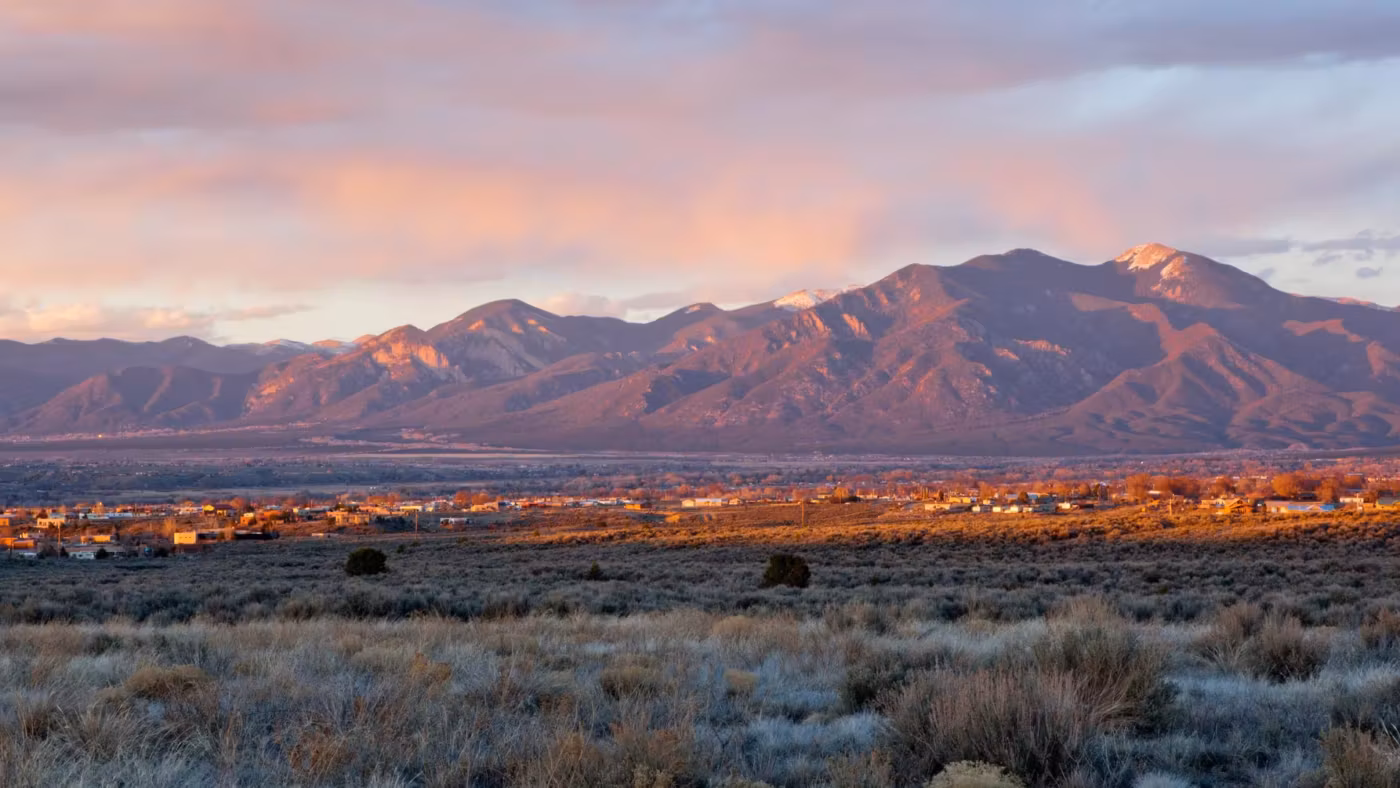 New Mexico mountains catching the last light above open scrub