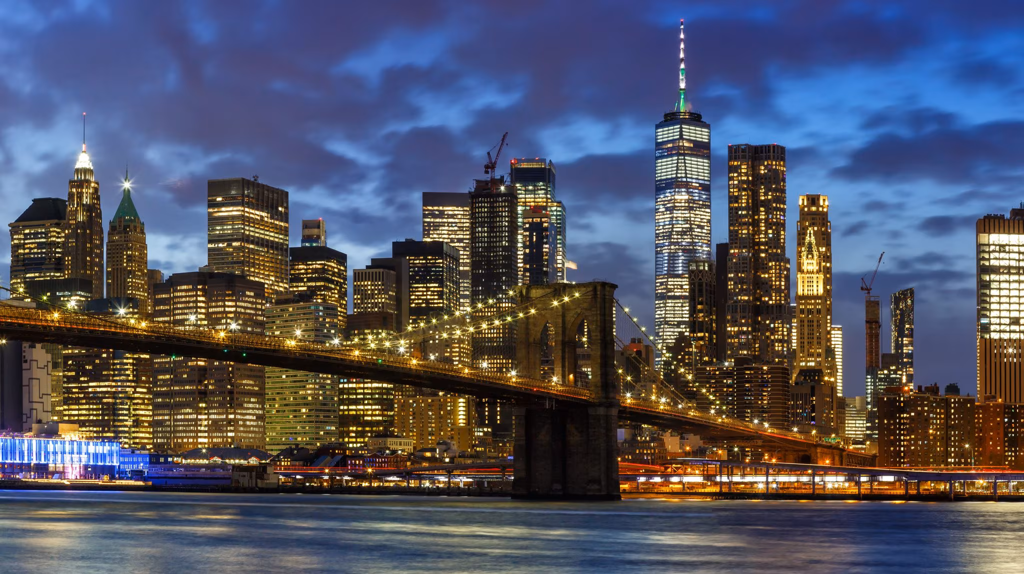 The Brooklyn Bridge and the Lower Manhattan towers lit at night
