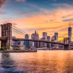 The Brooklyn Bridge at sunset with the Lower Manhattan skyline behind it