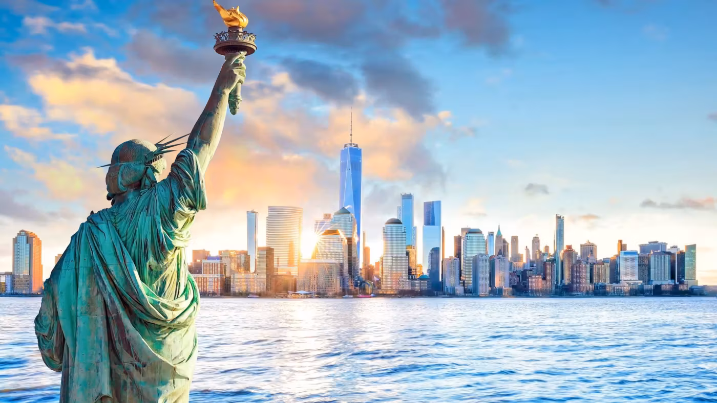 The Statue of Liberty's raised torch with the Manhattan skyline behind