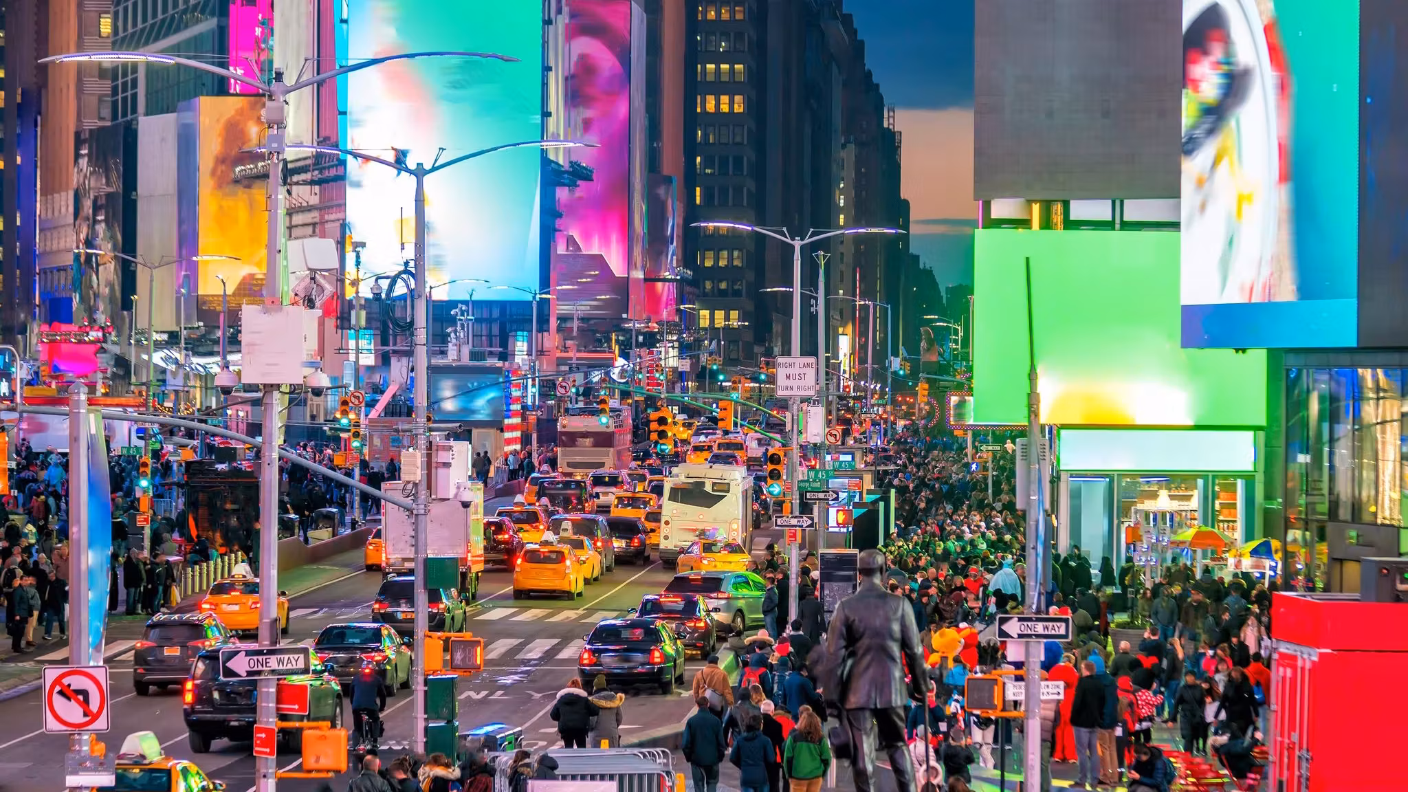 Crowds, cabs and illuminated screens in Times Square, New York