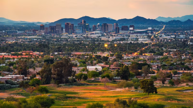 Desert and irrigated green on the edge of Phoenix with downtown in the distance