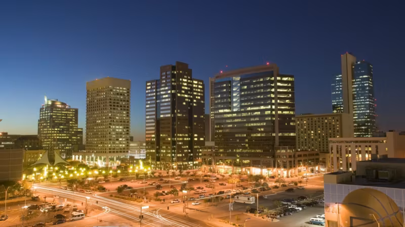 Downtown Phoenix towers at night above lit roads