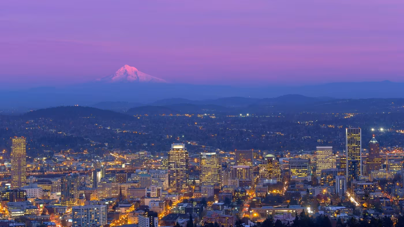 Portland's lights at dusk with Mount Hood on the horizon