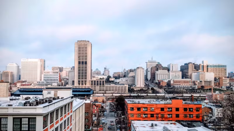Downtown Richmond from a rooftop, a bright red building in the foreground