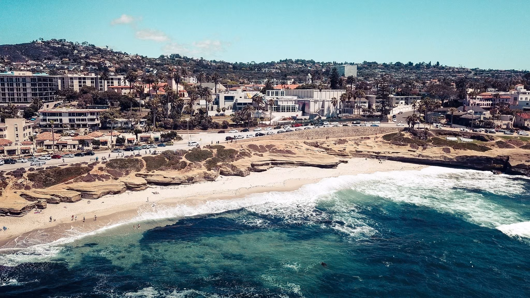 Houses above a cove and a sandy beach on the San Diego coast
