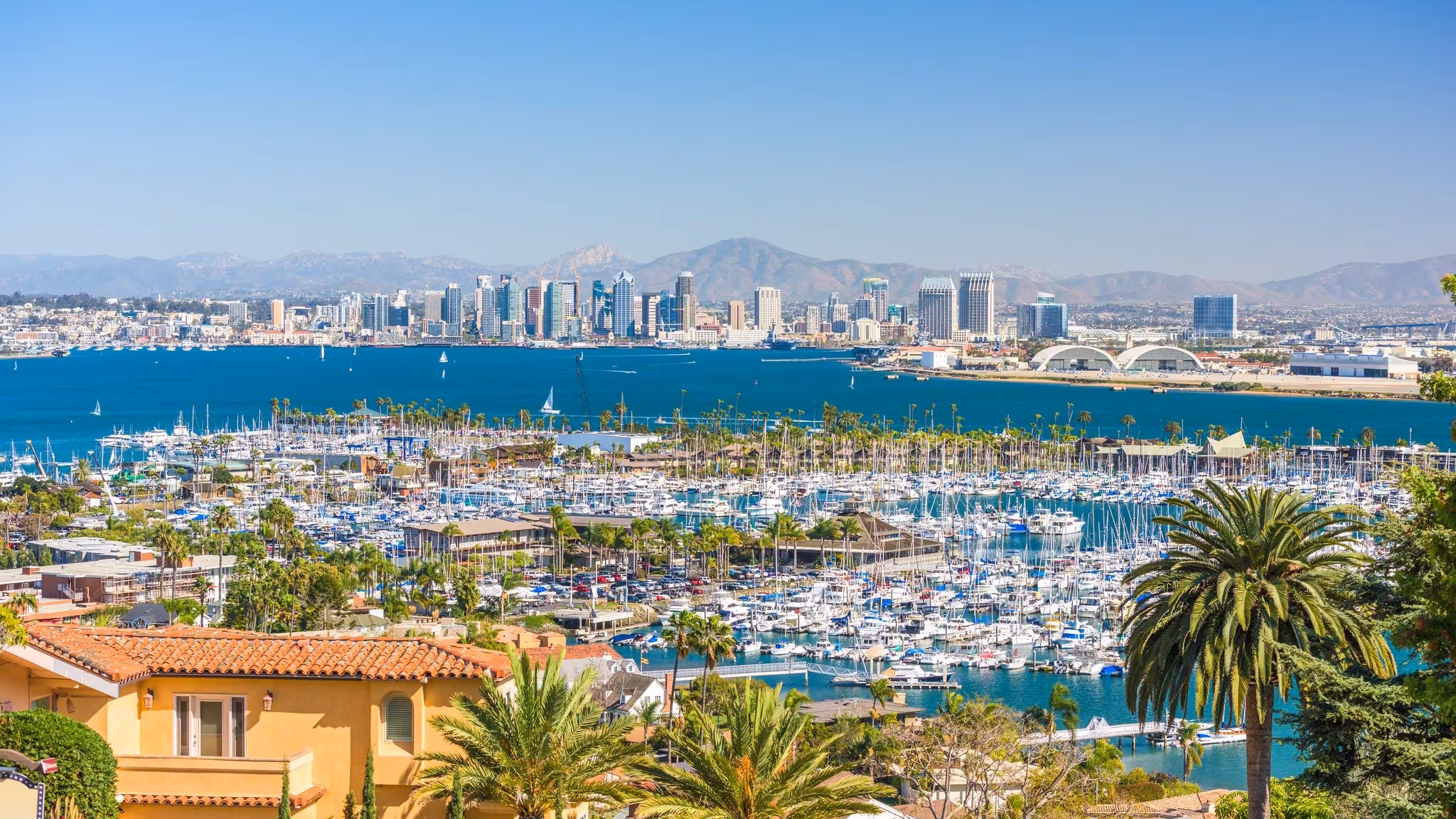 San Diego's marina and downtown seen over tile-roofed homes on a hillside