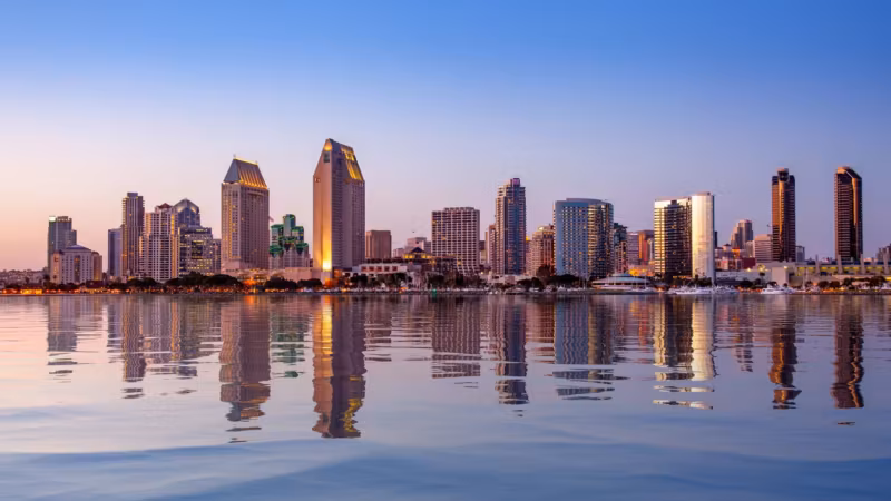 The San Diego skyline reflected across the bay at dusk