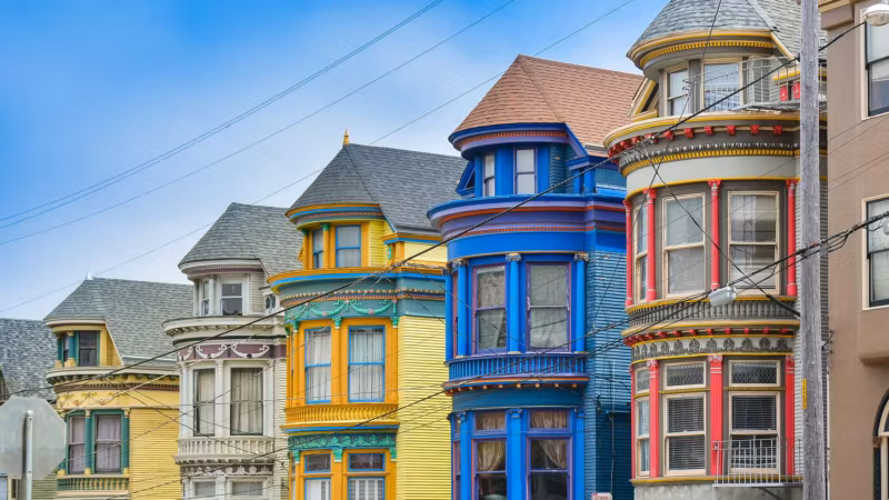 A row of brightly painted Victorian houses on a San Francisco street