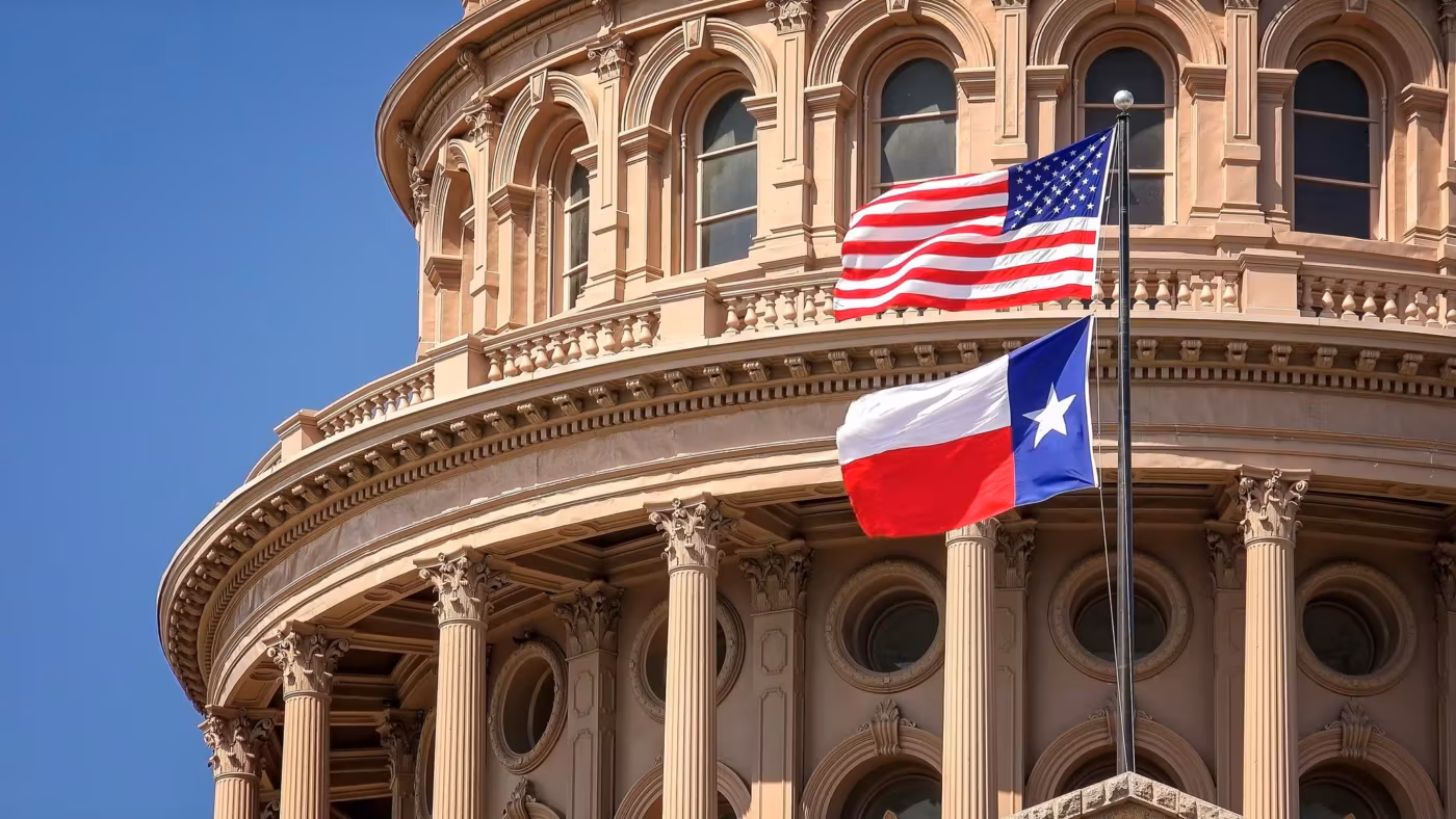 The Texas Capitol dome with the state and national flags flying