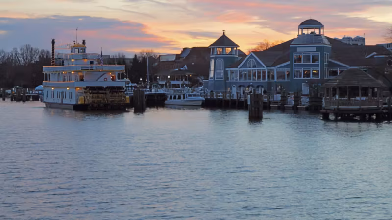 A riverboat moored at a Virginia waterfront at sunset