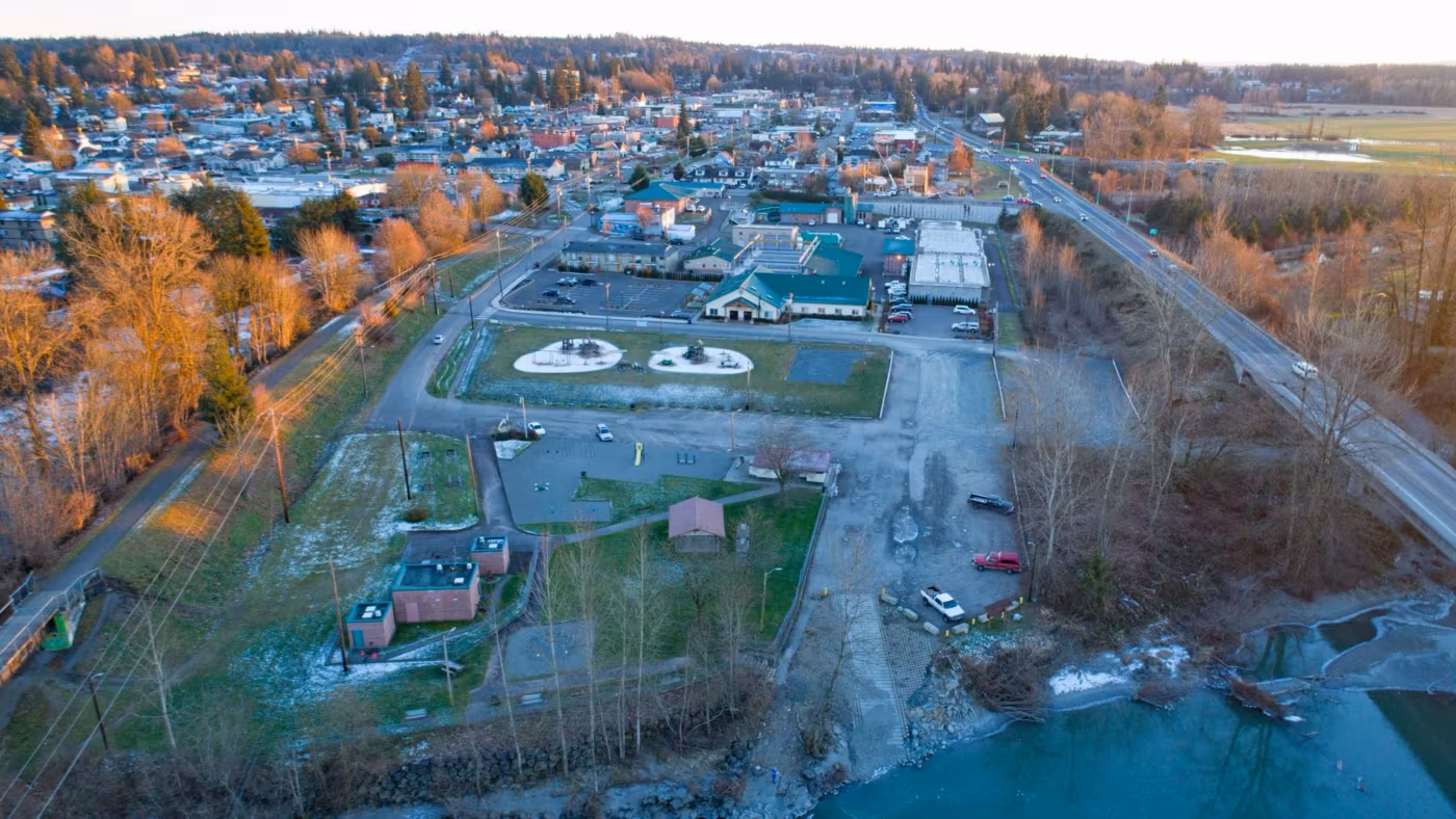 A small Washington town from the air in autumn, its park and railway beside the road